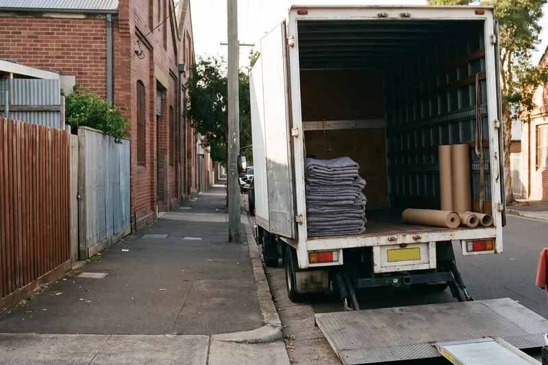 Moving truck parked at the kerb with the tail lift down